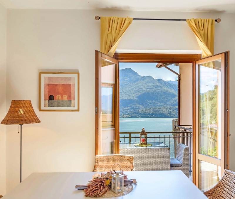 Picasso's dining room with French doors wide open onto a balcony over Lake Como and the mountains